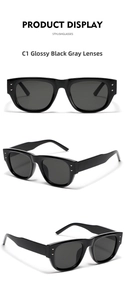 Detail of square black sunglasses featuring triangular metal rivets and grey lenses