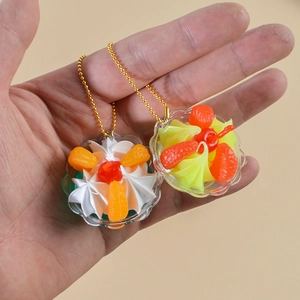 Miniature fake cream sundae keychain with fruit topping and golden ball chain