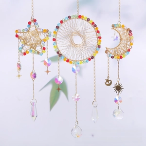 Detail of colorful crystal beads and star-moon pendants on gold metal dreamcatchers