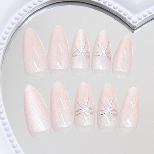 Pink cat eye almond press-on nails with silver 3D ribbon bows and pearl gradient effect