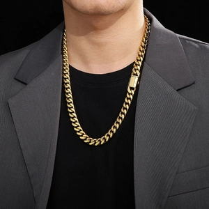 Detailed close-up of 12mm gold polished Cuban chain necklace with sleek box clasp on a model
