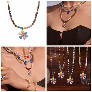 Detail of bohemian handmade flower pendant necklace with colorful beads and pearls