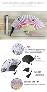Detail view of silk folding fan with cherry blossom patterns and bamboo ribs texture