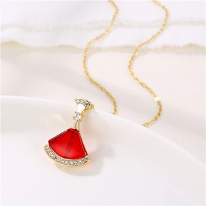 Detail of 18K gold necklace with red resin fan pendant and sparkling zircon accents