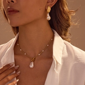 Baroque pearl jewelry set with gold-plated metal and toggle clasp shown on model