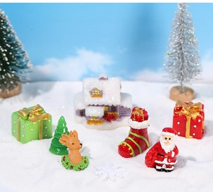 Miniature Christmas figurines set with Santa, reindeer and tree in a snowy landscape