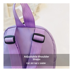 Detail of adjustable purple nylon backpack straps with durable black plastic buckles