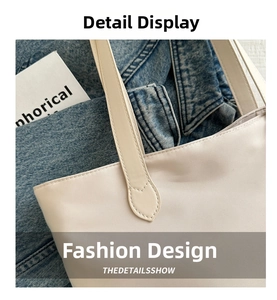 Macro detail of strap stitching on creamy white faux leather tote bag for women