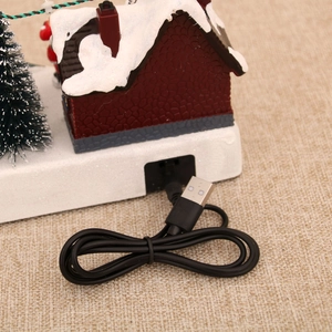Detailed view of the USB power port and cable for the glowing Christmas music box