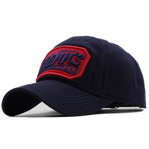 Detail of navy cotton baseball cap showing red embroidered SUPER badge and stitching