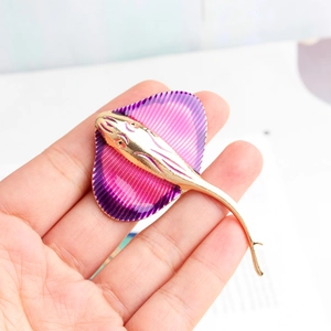Macro detail of alloy stingray brooch featuring purple pink gradient enamel finish