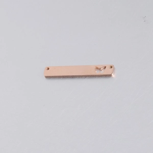 Detailed macro view of rose gold rectangle pendant with butterfly cutout design