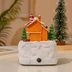 Detailed view of miniature Christmas house showing the DC power port and snowy base