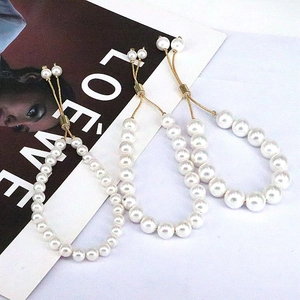 Detail view of adjustable freshwater pearl bracelets with gold-tone sliding drawstring clasp