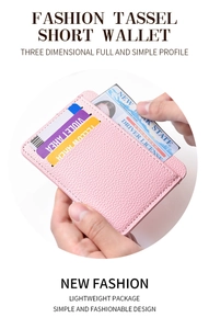 Close-up of pink litchi grain PU leather card holder with multiple slots held in hand