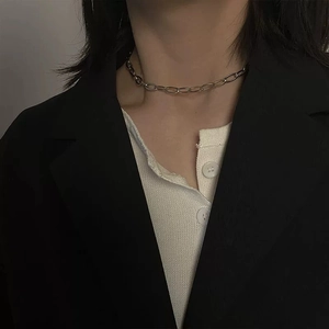 4mm stainless steel cross chain necklace for men and women worn on a black blazer