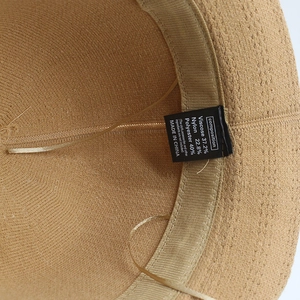 Detail shot of woven sun hat interior with sweatband and fabric composition label
