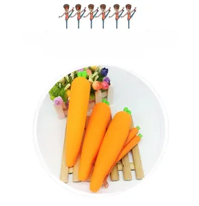 Detailed view of carrot-shaped silicone pencil cases in various sizes on a wooden tray