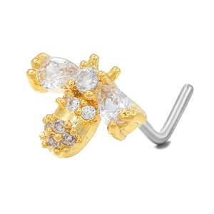 Detailed view of a gold bee nose stud featuring shimmering cubic zirconia on an L-shaped bar