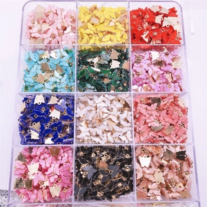 Selection of colorful butterfly charms in a plastic storage box for DIY jewelry making
