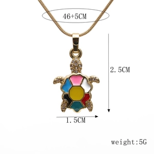 Detail view of colorful enamel turtle pendant necklace showing dimensions 2.5cm by 1.5cm