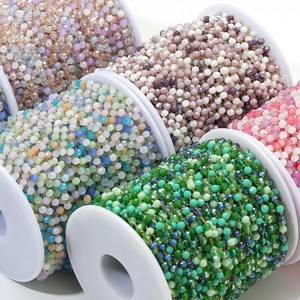 Macro shot of 3mm amethyst crystal bead chains on white spools for jewelry making