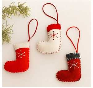 Detail of 3-piece knitted Christmas stockings with snowflake patterns and hanging loops