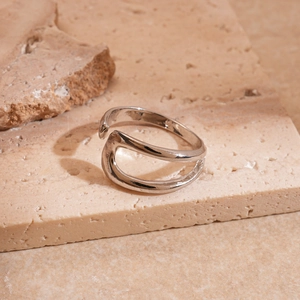 Detail of silver wavy open rings with a double-layered minimalist geometric design