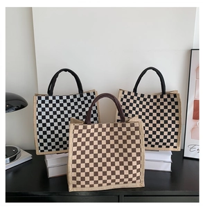 Detailed texture of large capacity checkered tote bags in black, beige and brown