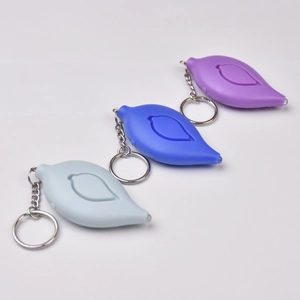 Close-up of leaf-shaped mini LED flashlights with keychains in blue, purple and grey