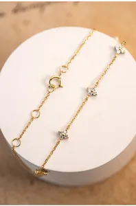 Macro detail of 18K gold S925 silver four-leaf clover bracelet with sparkling zircon stones