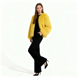 Close-up of fluffy bright yellow faux fur jacket texture and soft plush material