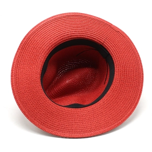 Detailed top view of red straw fedora hat showing fine weave and black sweatband