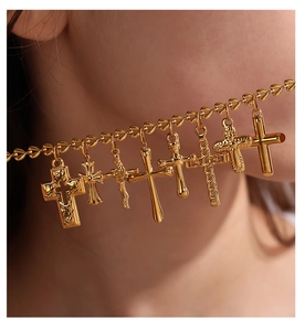 Close-up of golden multi-cross pendant necklace with vintage metallic texture