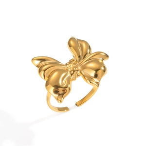 Detailed macro view of a large golden bow-shaped adjustable open ring in a polished finish