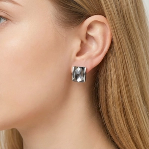 Close-up of elegant square dark grey crystal earrings with 18K gold plated base on model