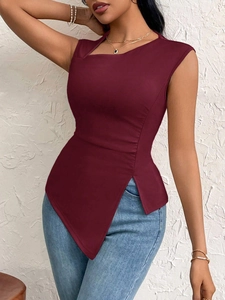 Detail of burgundy sleeveless top with asymmetrical neckline and pointed hem
