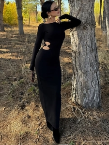 Slim fit long sleeve black dress featuring a stylish waist cut-out with metal ring
