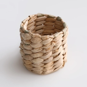 Macro shot of handcrafted natural straw napkin ring showing intricate woven texture details