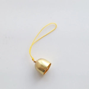 Detailed close-up of a 2cm golden metal Christmas bell with a yellow hanging cord