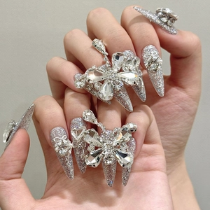 Luxury silver stiletto press-on nails featuring heavy handcrafted crystal butterfly charms