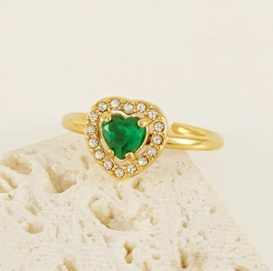 Macro view of 18K gold double-layer heart ring with green zircon and pavé crystals