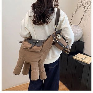 Detail of creative horse-shaped brown canvas crossbody bag with adjustable shoulder strap