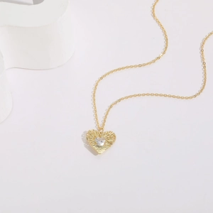 Minimalist 14K gold plated tree of life heart necklace with zircon stone on white background