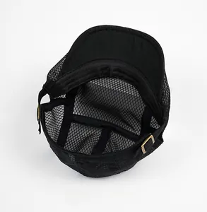 Detail view of the black mesh flat cap showing internal structure and adjustable metal buckle