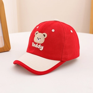 Close-up of embroidered Teddy bear patch on cotton baseball cap with curved brim