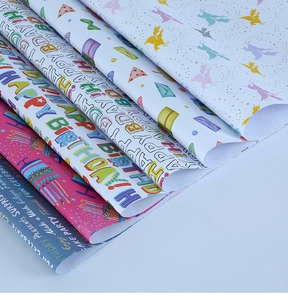 Detail of colorful Happy Birthday gift wrapping paper with unicorn and cake patterns