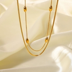 Double-layered 18K gold plated stainless steel necklace with oval bean charm on silk