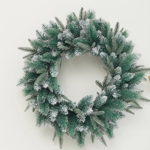 Green frosted pine needle Christmas wreath with realistic snow flocking and dense foliage