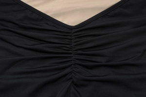 Macro shot of V-neckline featuring elegant lace patchwork and ruched fabric details